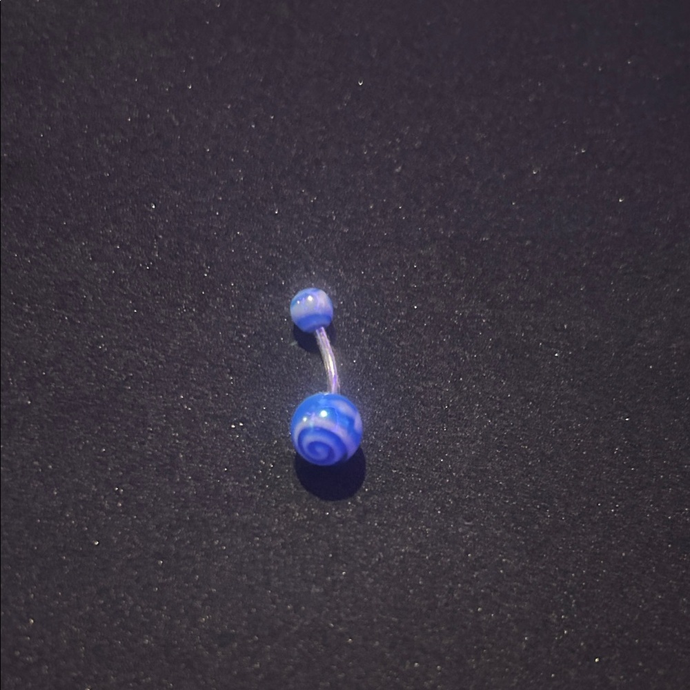 Blue swirly navel piercing.